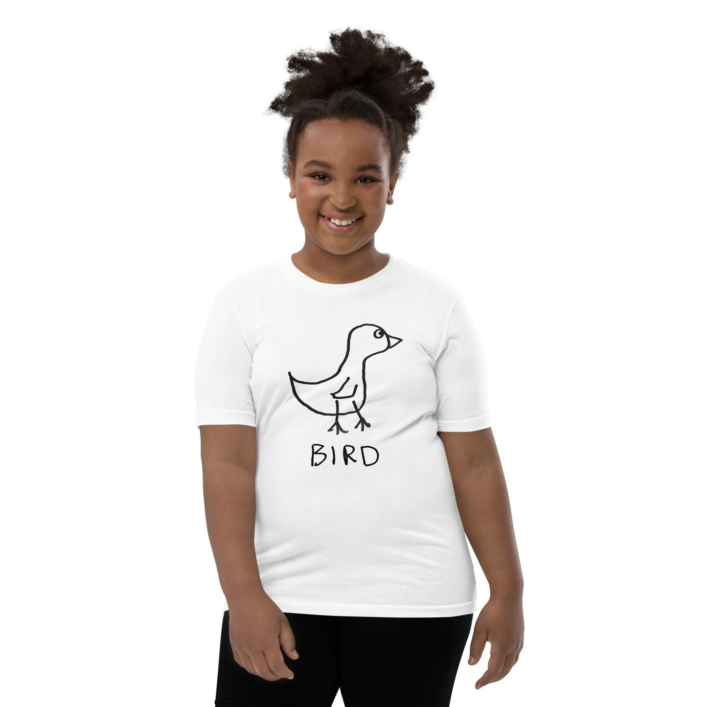 Young girl wearing a t-shirt featuring a crudely drawn black marker drawing of a bird with the word "Bird" underneath