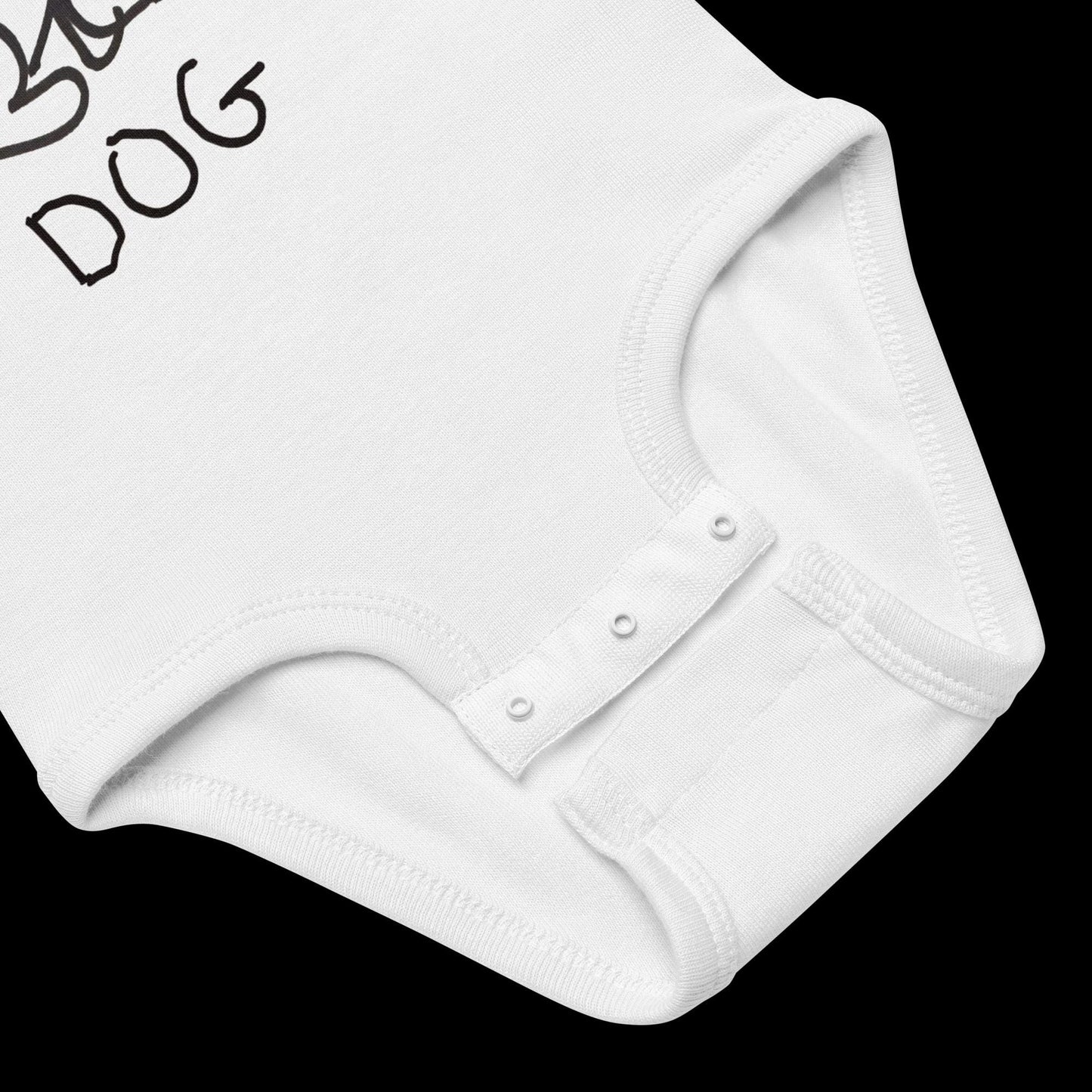 closeup of baby onsie featuring a crude marker black and white marker drawing of a cute dog with the word "DOG" handwritten underneath