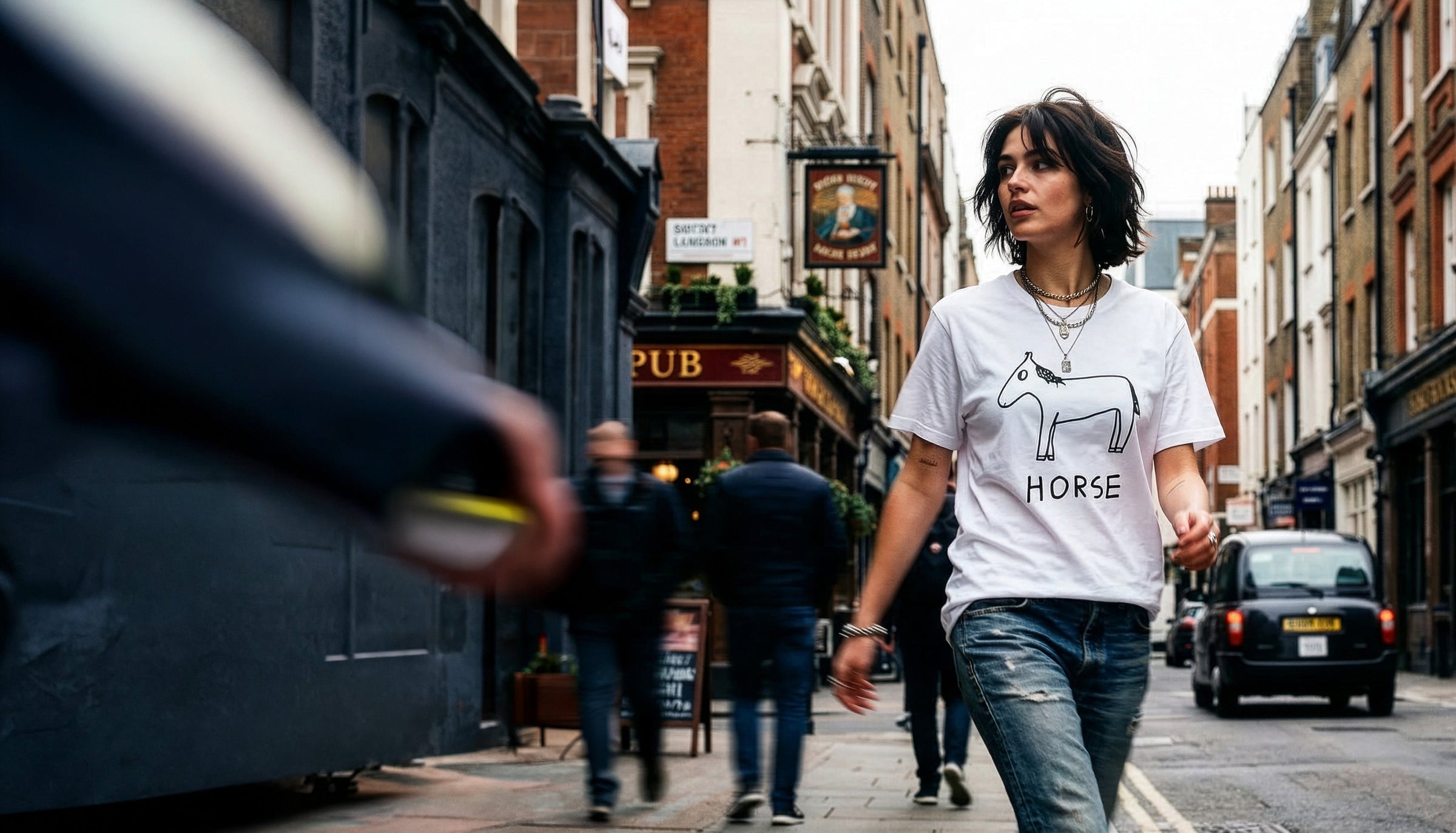 Classic Tees - LoFi Animal Shirts - woman walks through London wearing a white t-shirt with a lo-fi hand-drawn horse graphic