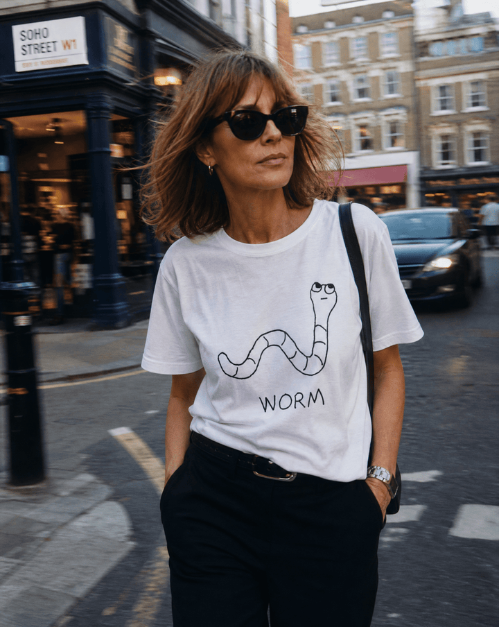 Woman walking a SoHo shopping street in a lo-fi Worm Women&
