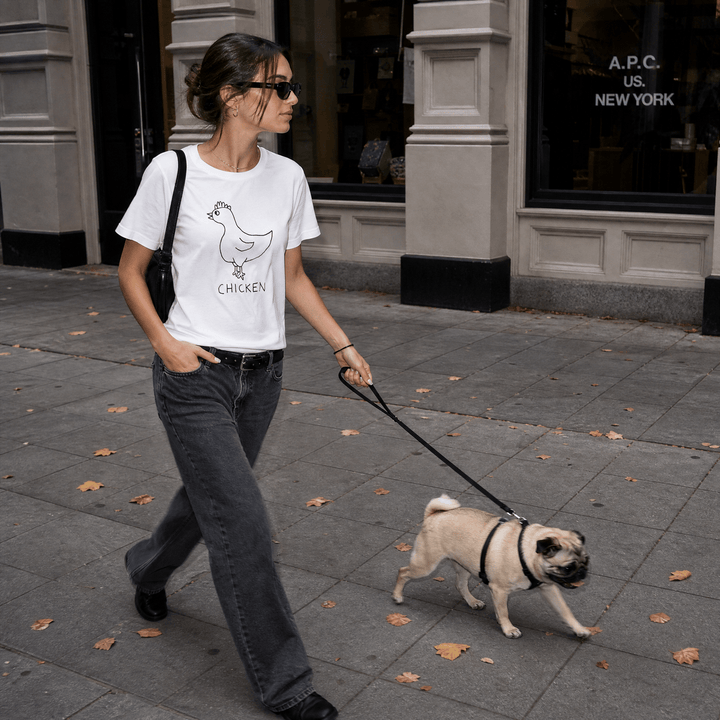 Woman walking a dog on a city street in a lo-fi Chicken Women&