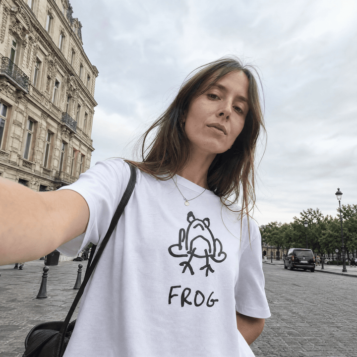 Woman taking a selfie on a European street wearing a lo-fi Frog Women&