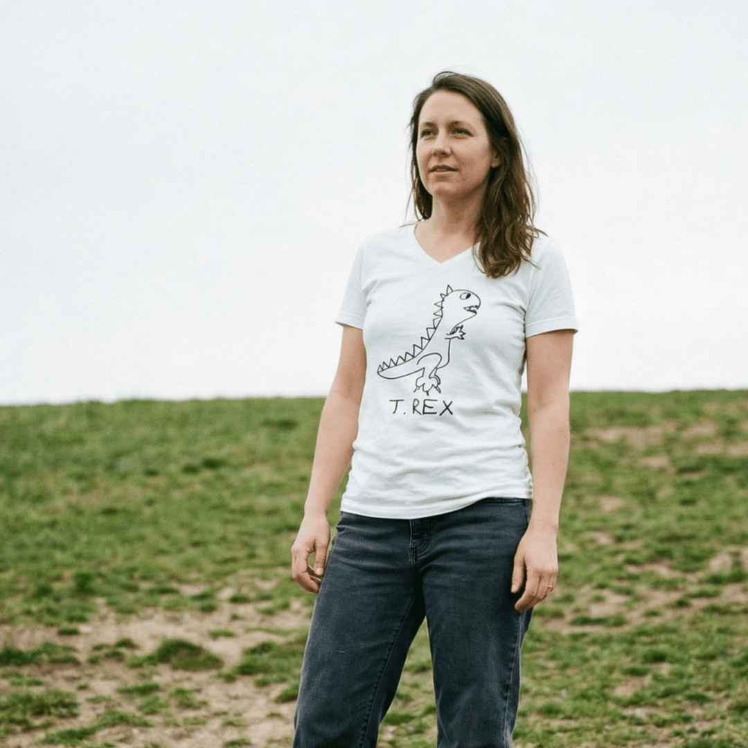 Woman standing in a grassy field wearing a lo-fi T. Rex V-Neck T-Shirt