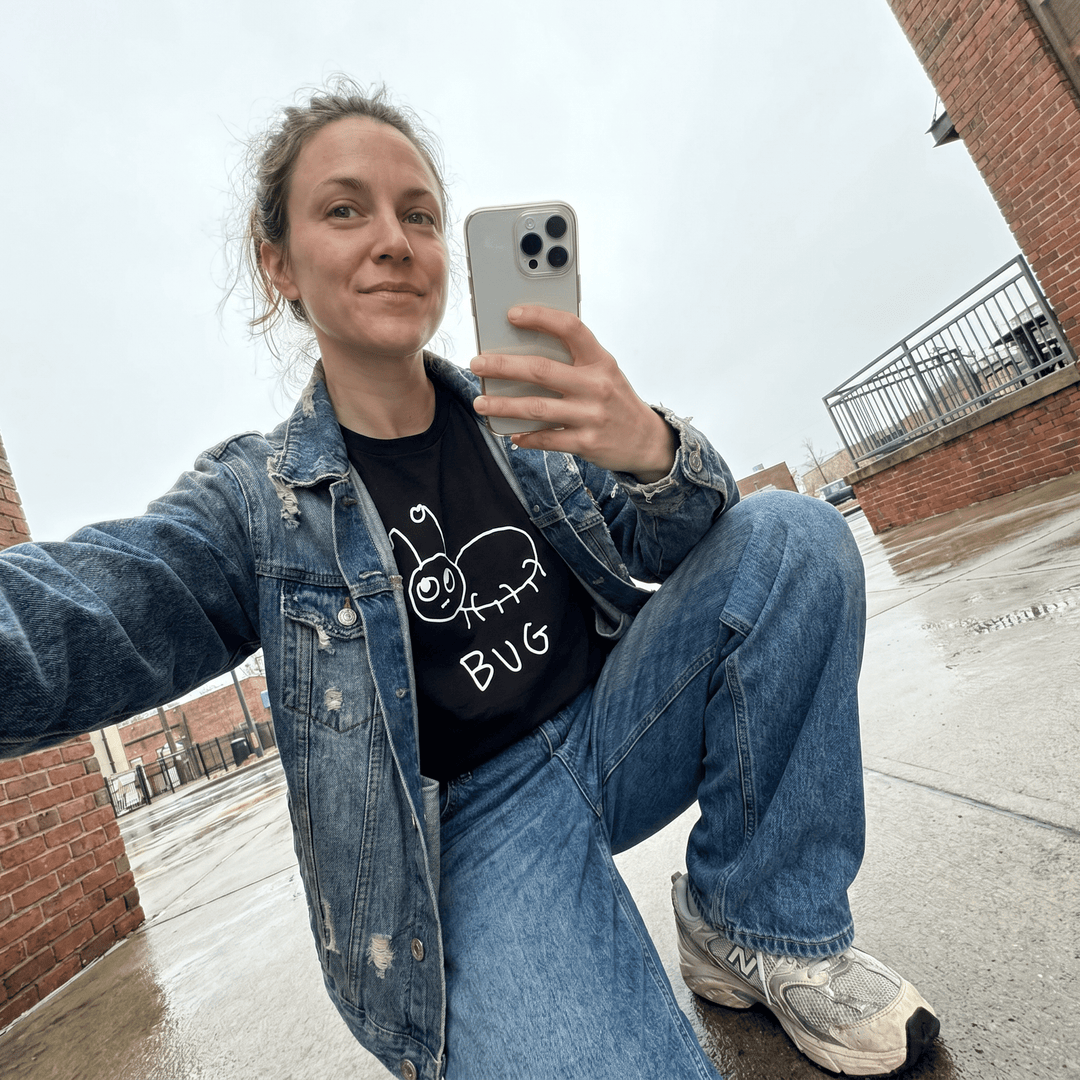 Woman taking a street selfie in a lo-fi Bug Women&