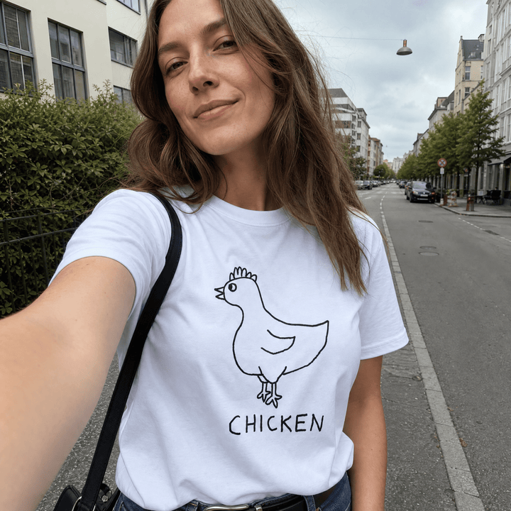 Woman taking a street selfie in a lo-fi Chicken Women&