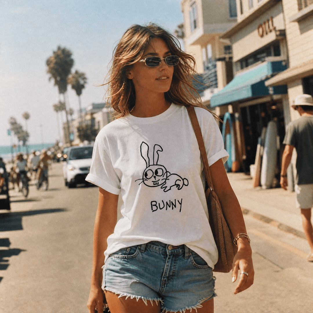Woman walking a palm-lined beach town street in a lo-fi Bunny Women&