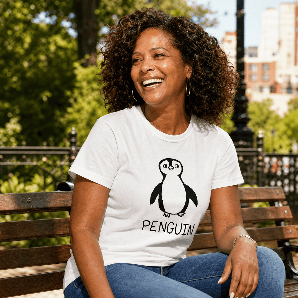Woman seated on a park bench in a lo-fi Penguin Women's Relaxed T-Shirt in white
