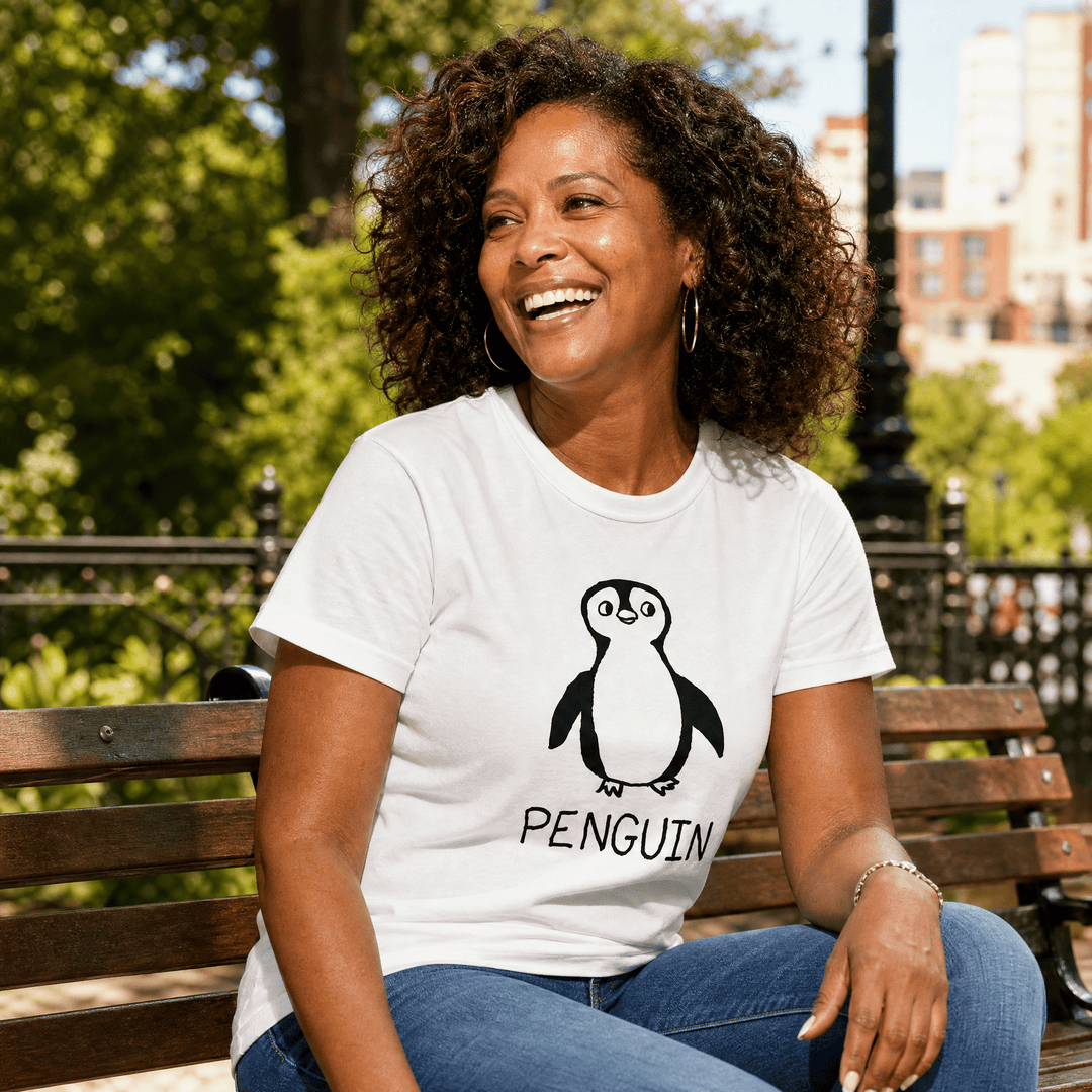 Woman seated on a park bench in a lo-fi Penguin Women&