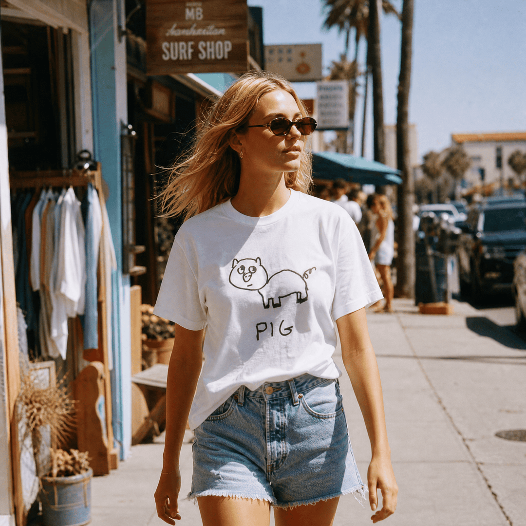 Woman walking a palm-tree beach town street wearing a lo-fi Pig Women&