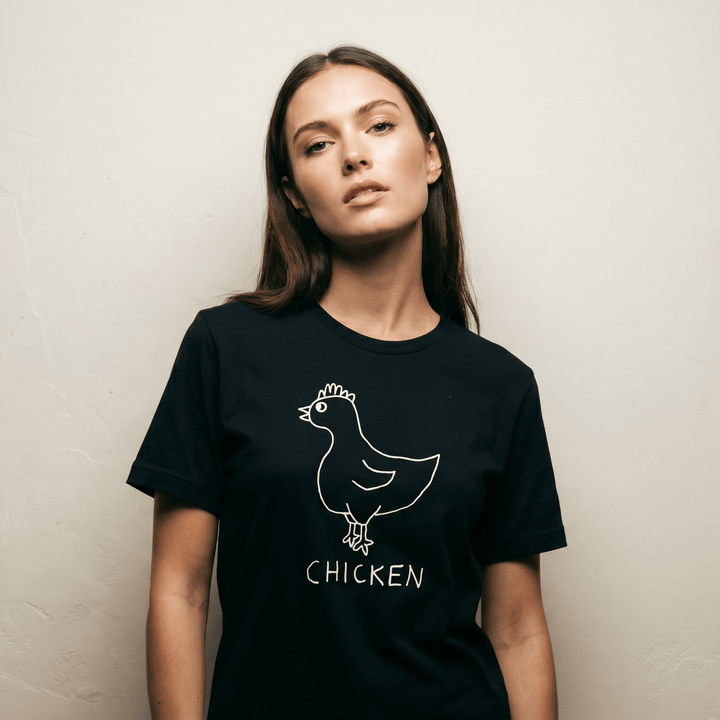 Woman in a minimalist studio portrait wearing a lo-fi Chicken Women&