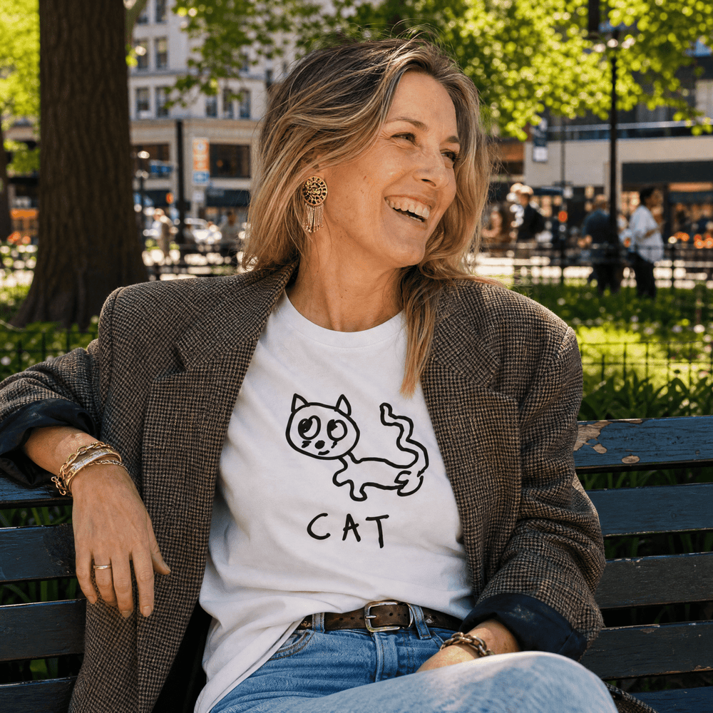 Woman in a park wearing a blazer over a lo-fi Cat Women's Relaxed T-Shirt in white