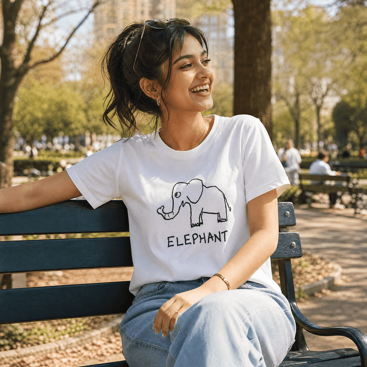 Woman seated on a park bench in a lo-fi Elephant Women&