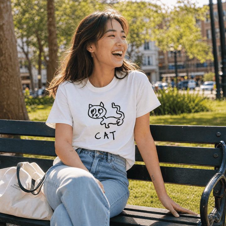 Woman seated on a park bench in a lo-fi Cat Women&