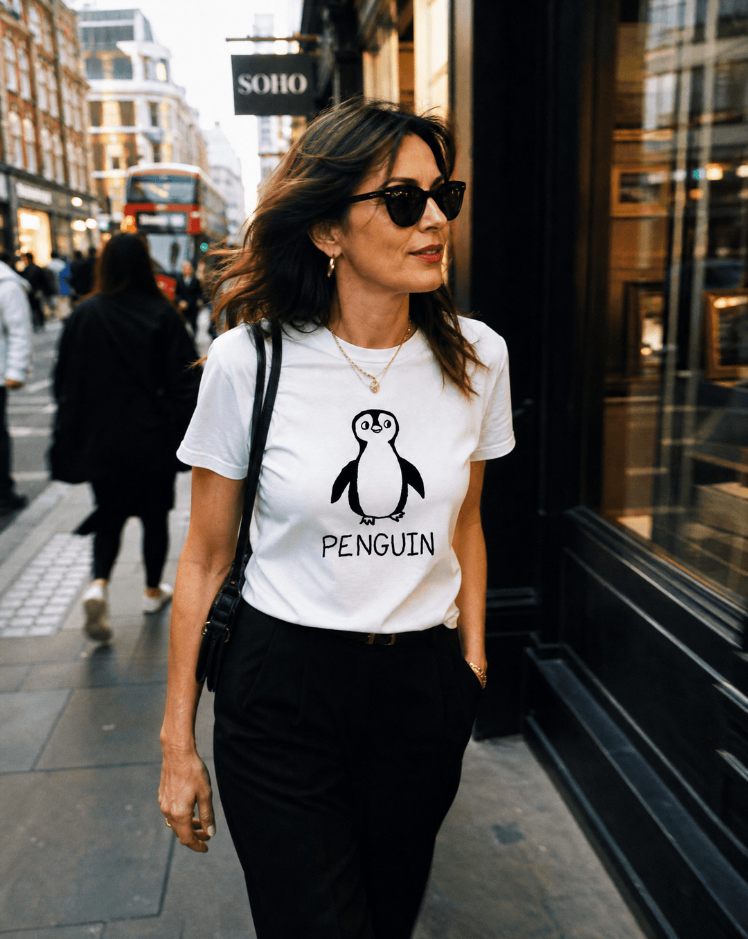 Woman walking a SoHo shopping street wearing a lo-fi Penguin Women&