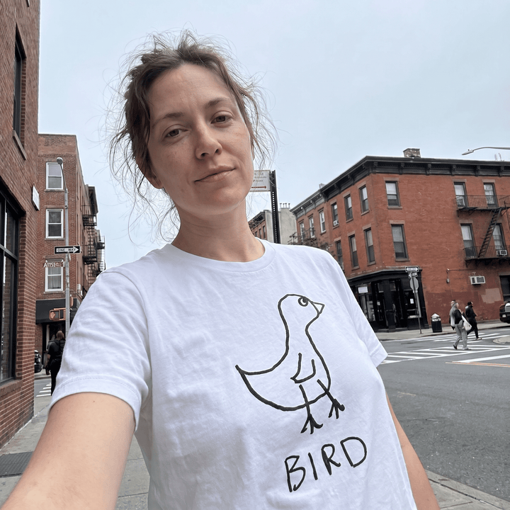 Woman taking a street selfie in a lo-fi Bird Women&