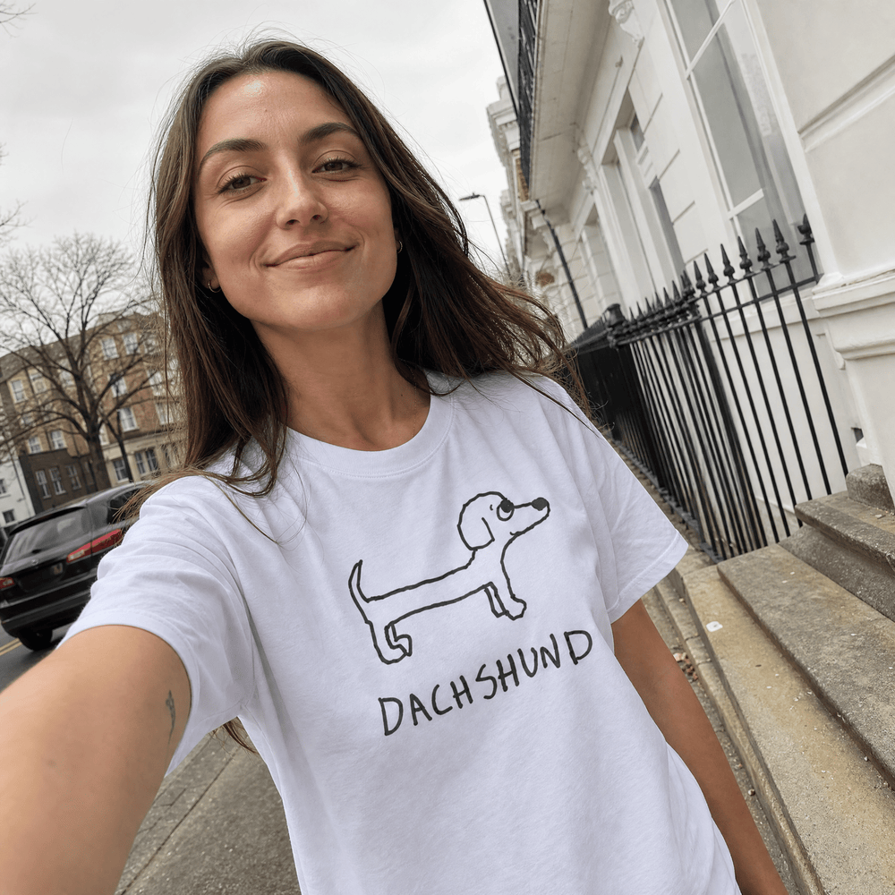Woman taking a street selfie in a lo-fi Dachshund Women's Relaxed T-Shirt in white