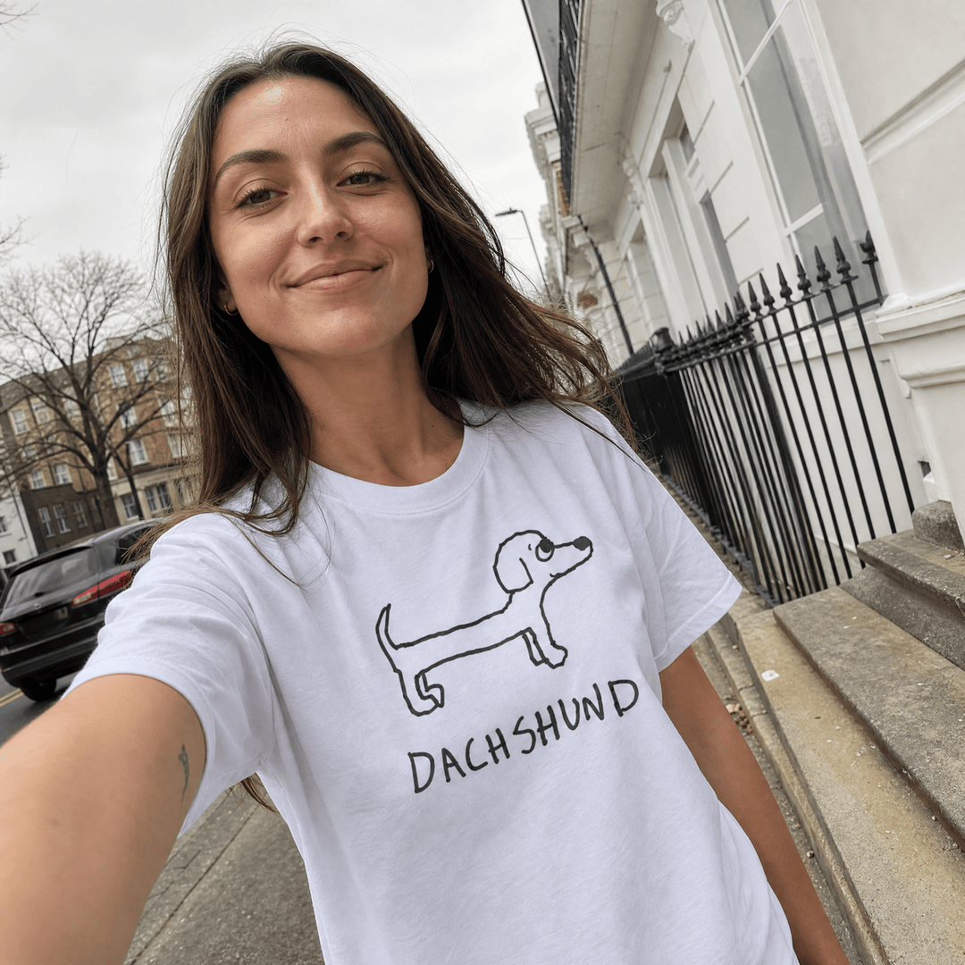 Woman taking a street selfie in a lo-fi Dachshund Women&