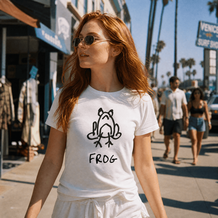 Woman walking a sunny beach town street with palms wearing a lo-fi Frog Women&