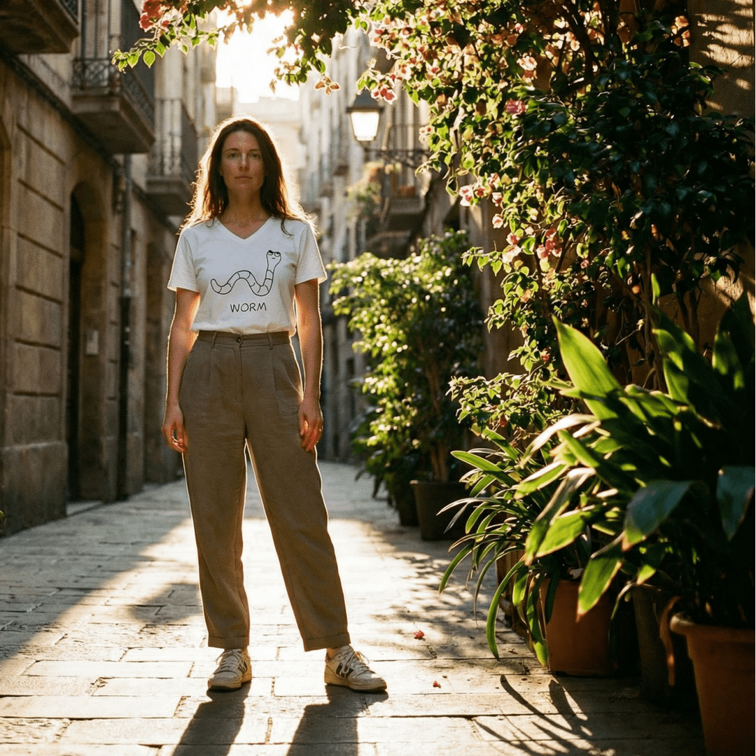 Woman in a flower-draped European lane wearing a lo-fi Worm V-Neck T-Shirt