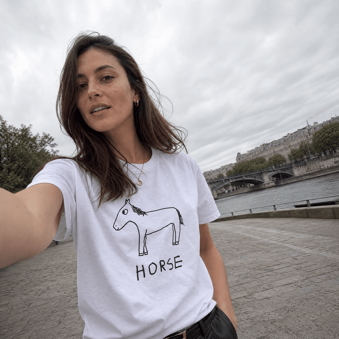 Woman taking a street selfie in a lo-fi Horse Women&
