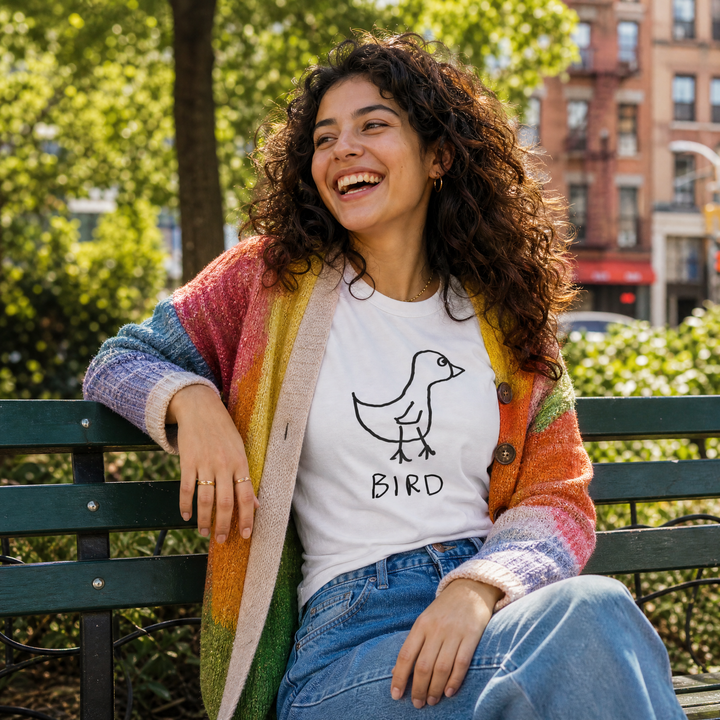 Woman seated on a park bench in a lo-fi Bird Women&