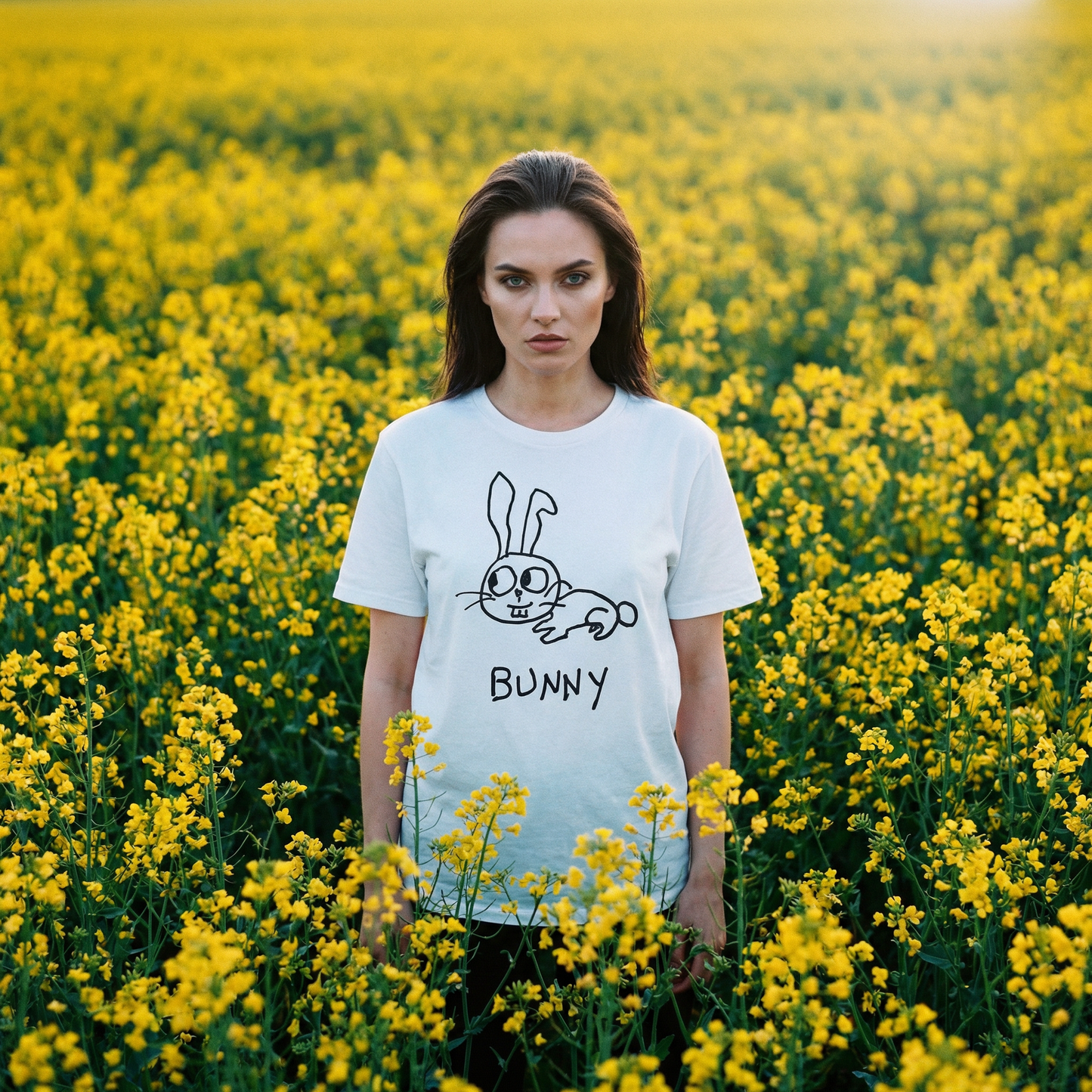 Bunny shirt worn outdoors in a field of yellow flowers – minimalist lofi bunny tee in natural setting
