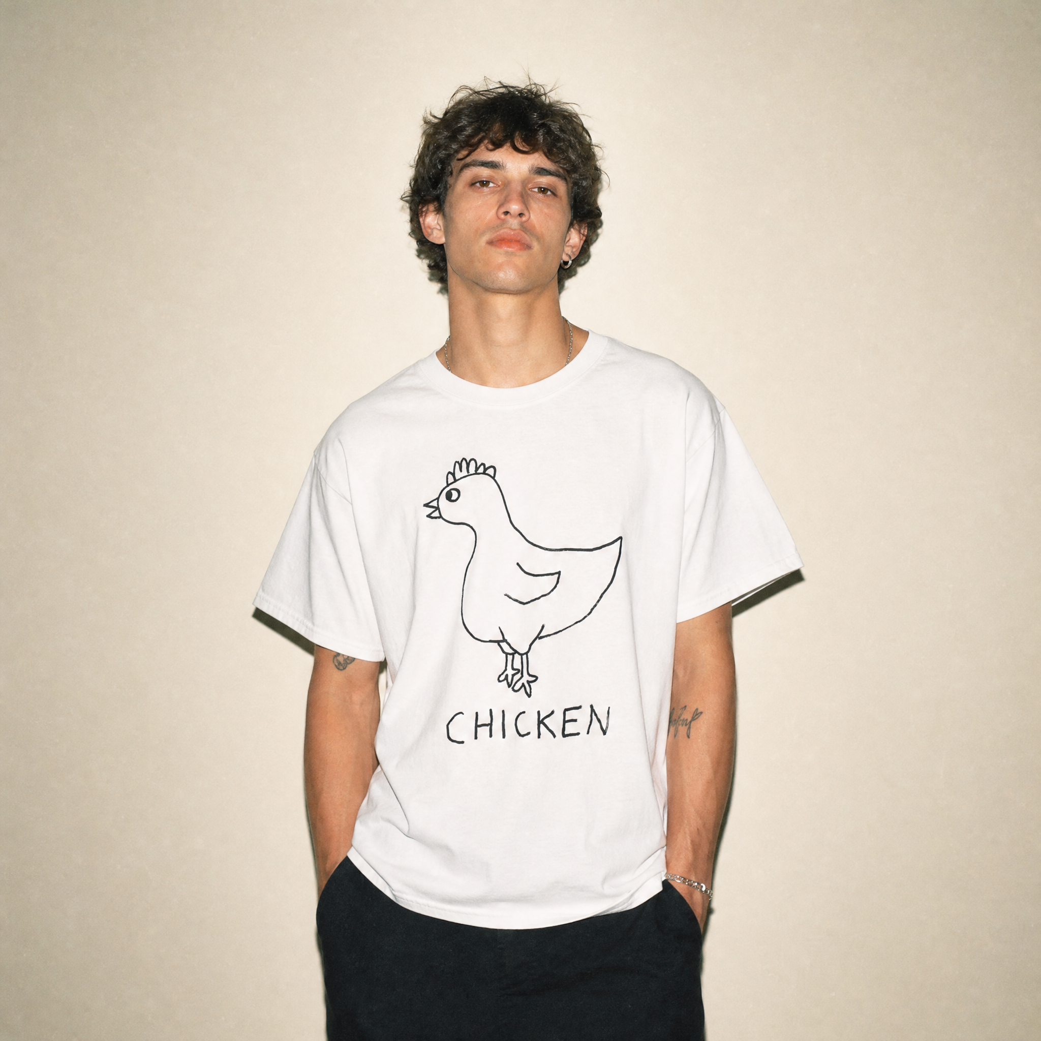 Man in a studio wearing a lo-fi Chicken Classic Tee