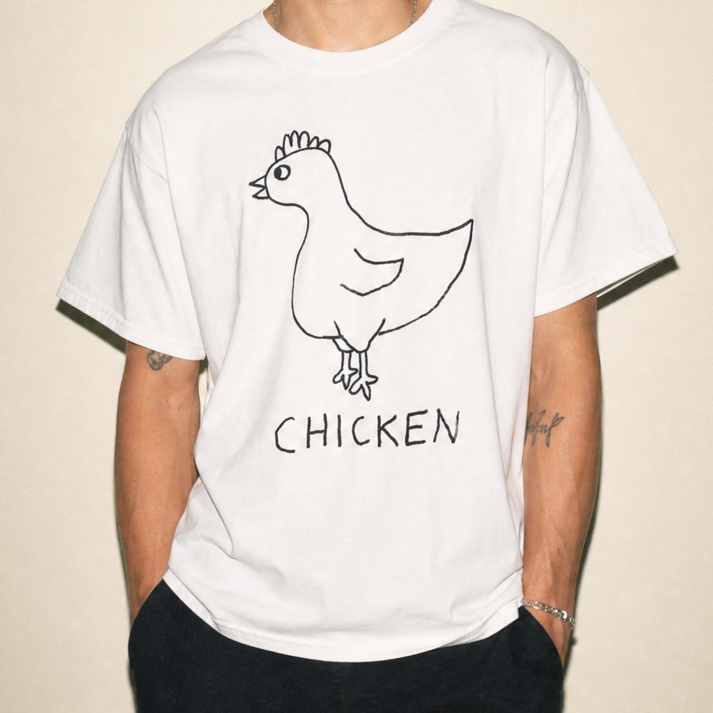 Person wearing a white t-shirt with a lo-fi hand-drawn chicken graphic and 'CHICKEN' text on a beige background
