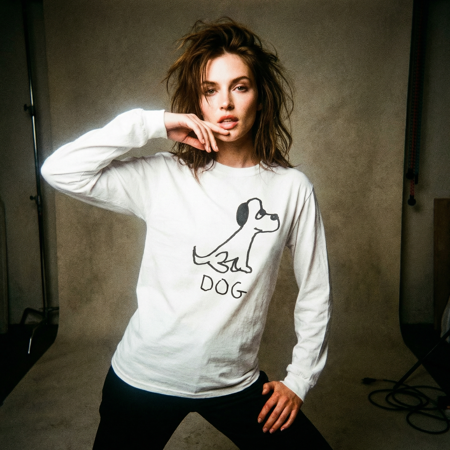 Model in a dog graphic long sleeve posed in a faded, grainy 90s-era photo shoot