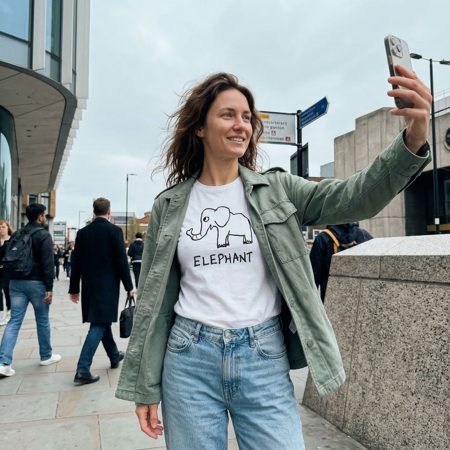 Woman taking a selfie on a city street  wearing an Elephant graphic tee  – lofi animal shirt streetwear style