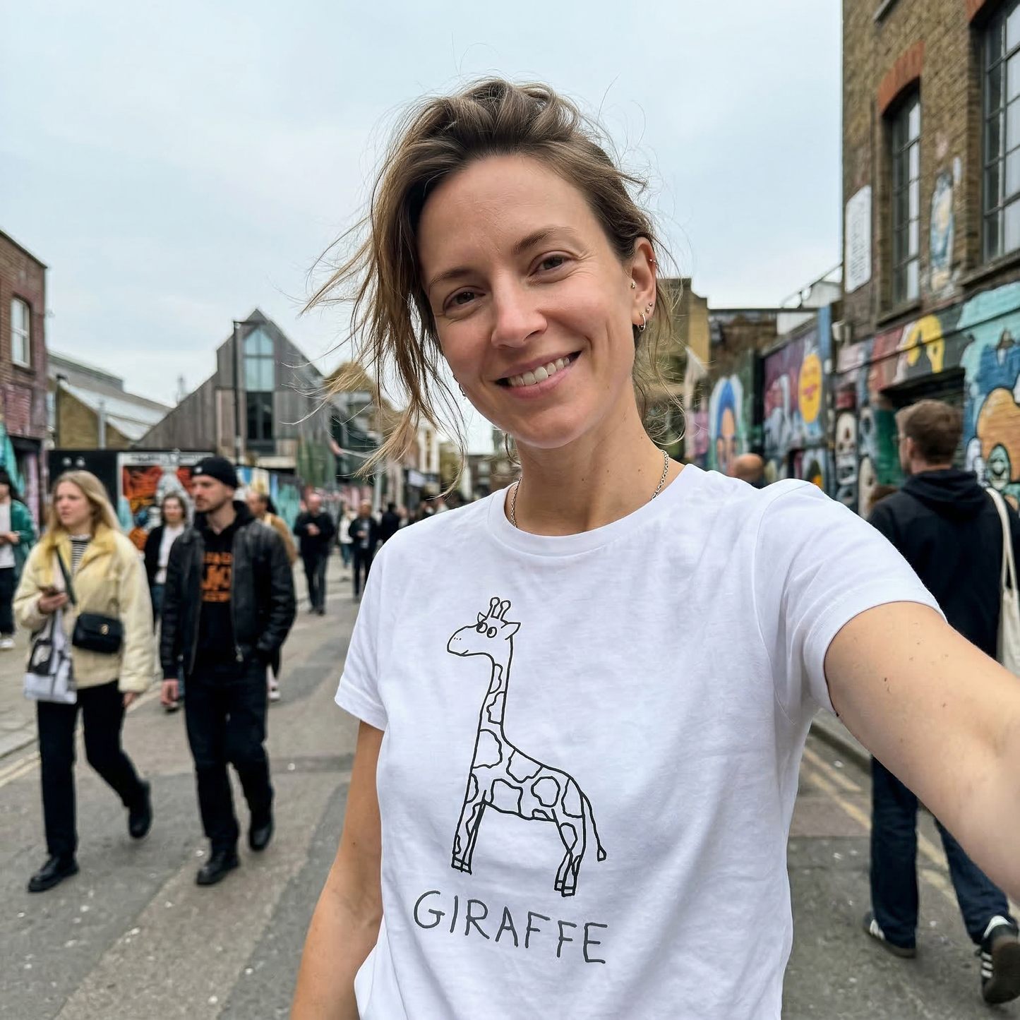 Woman wearing a white Gildan 5000
Giraffe graphic tee worn on city street – lofi animal shirt streetwear style