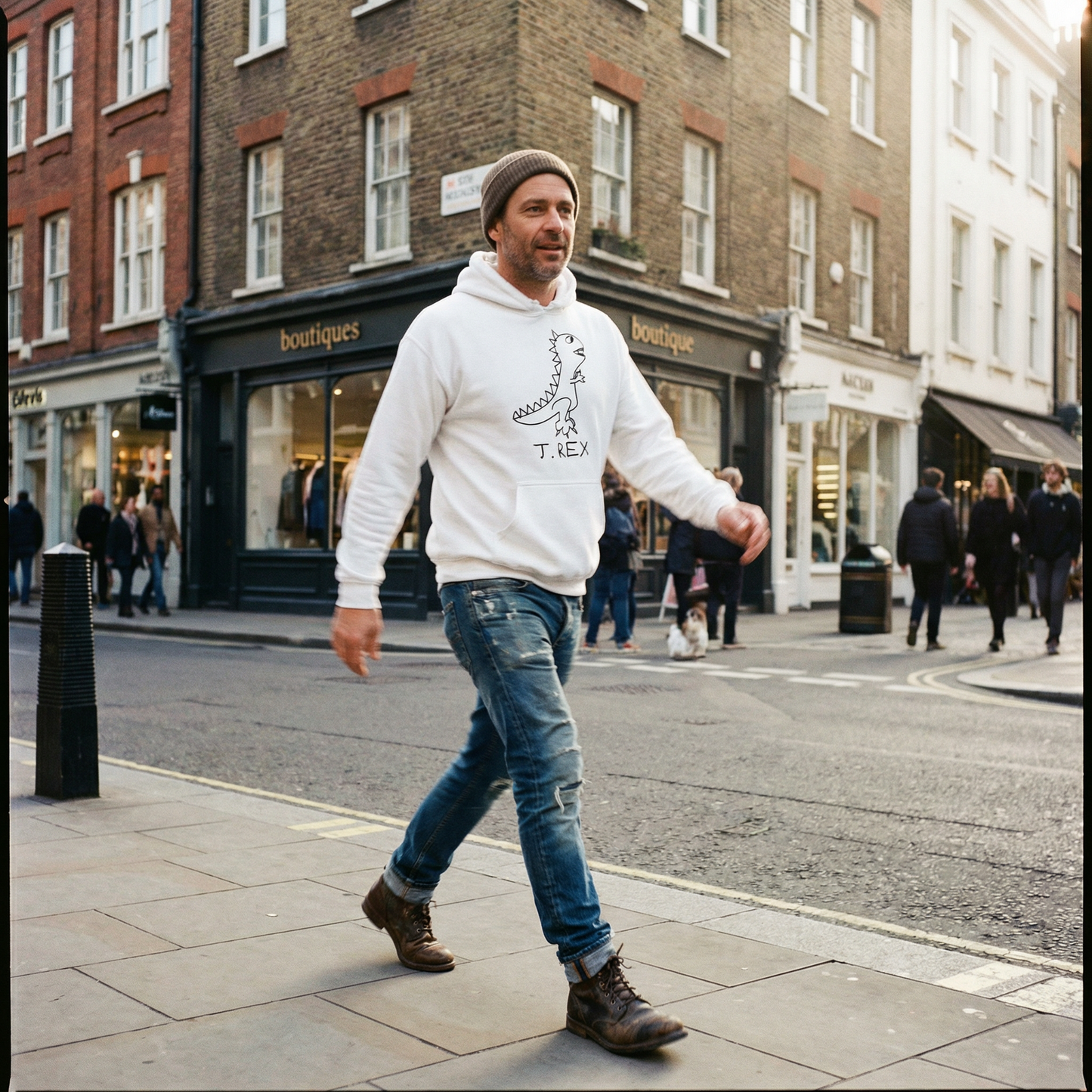 T-Rex graphic hoodie worn by man with hat on London Soho city street – lofi dinosaur streetwear