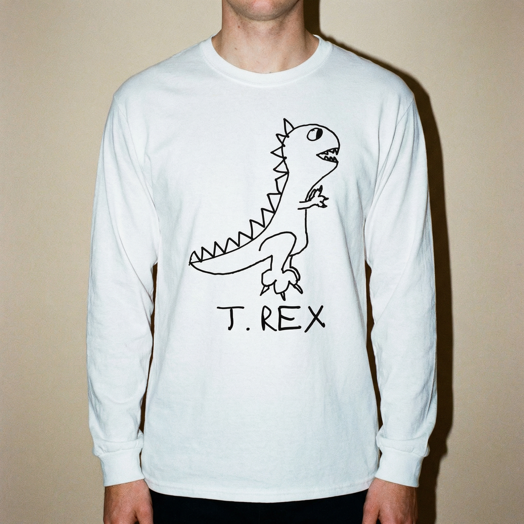 Model in a T-Rex long sleeve tee posed confidently against a clean dark backdrop