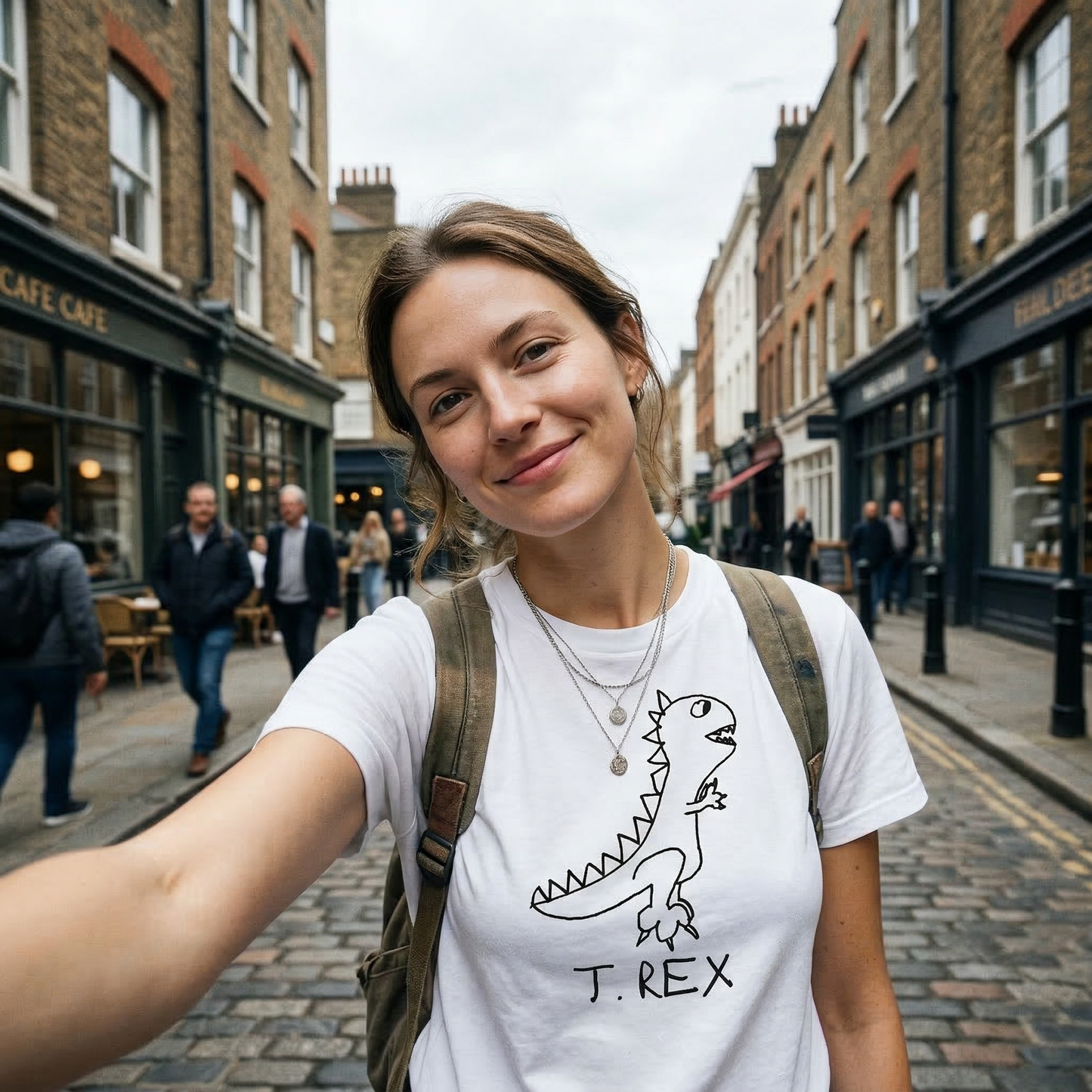 T-Rex classic tee in Paris street setting – quirky dinosaur graphic tee