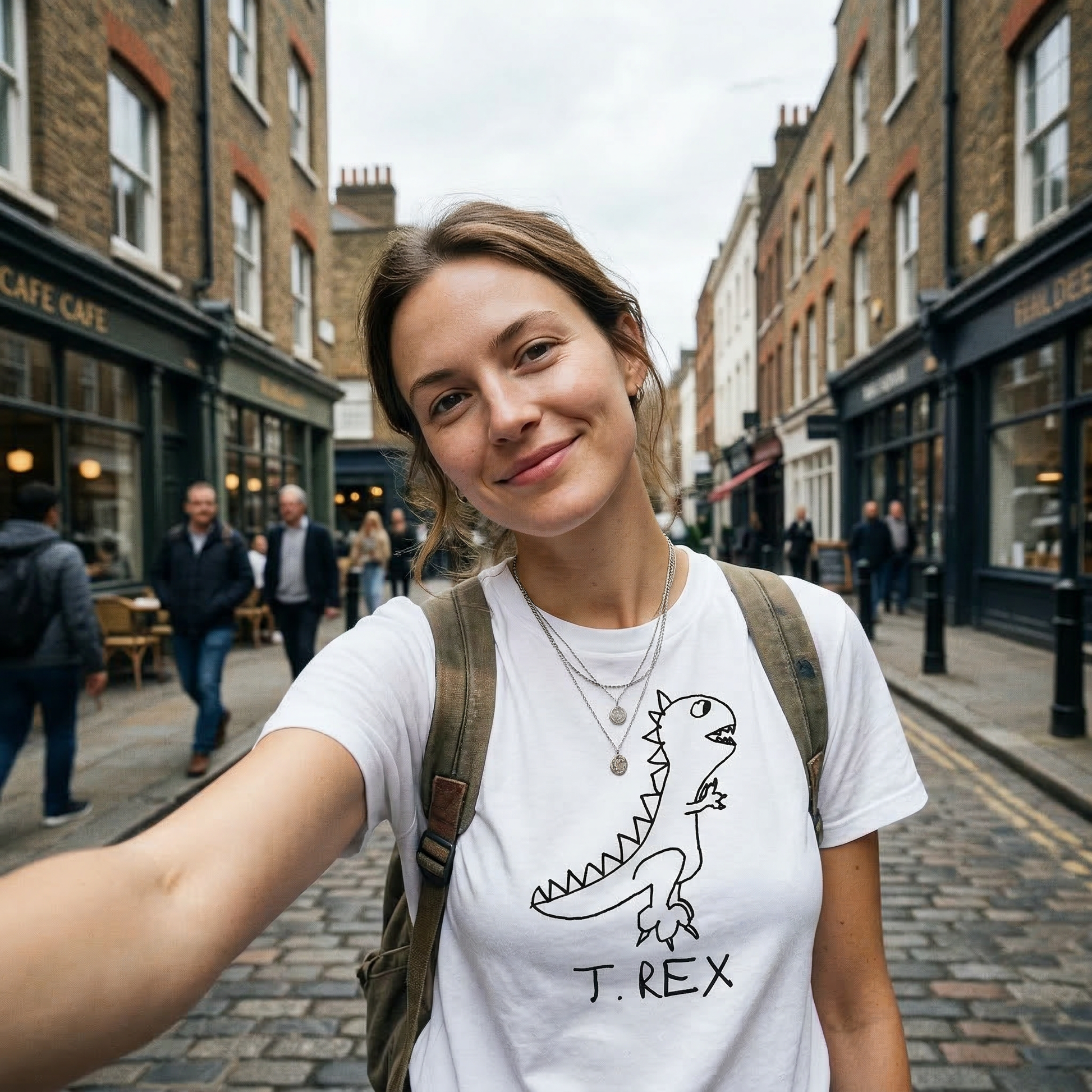 T-Rex classic tee in Paris street setting – quirky dinosaur graphic tee