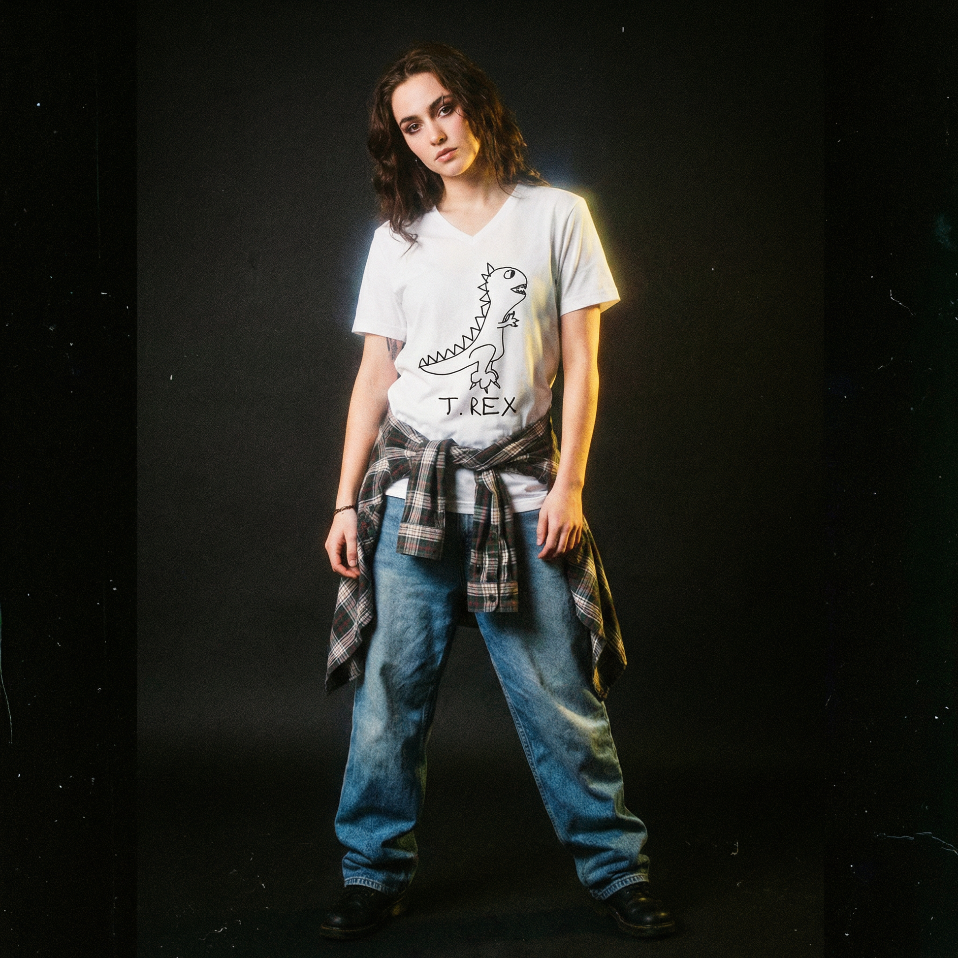 Person wearing a white T Rex graphic v-neck t-shirt with a dinosaur graphic in a 90s grunge style clothing and photo style