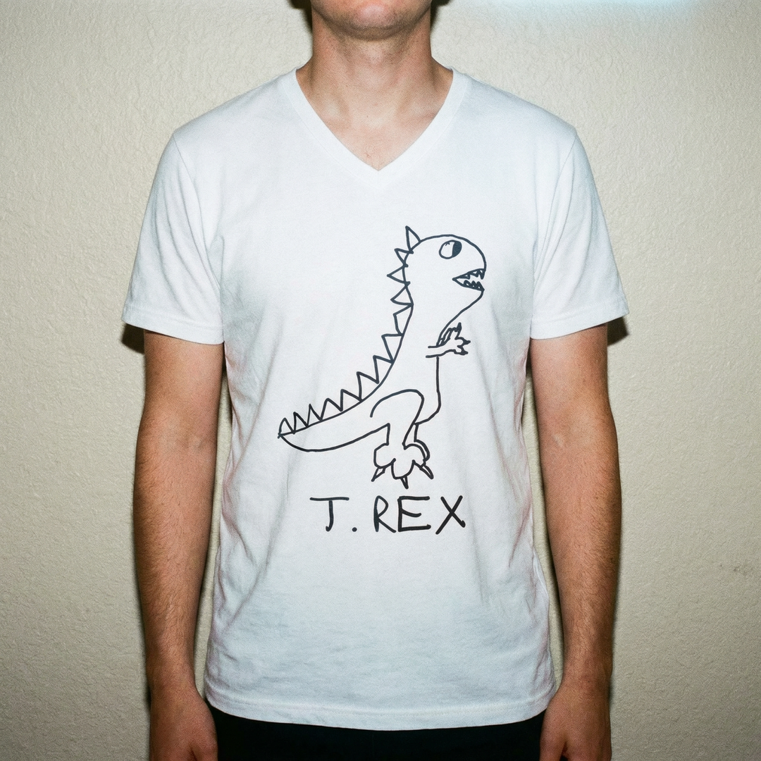 Model in T-Rex v-neck tee, bold stance, clean studio background