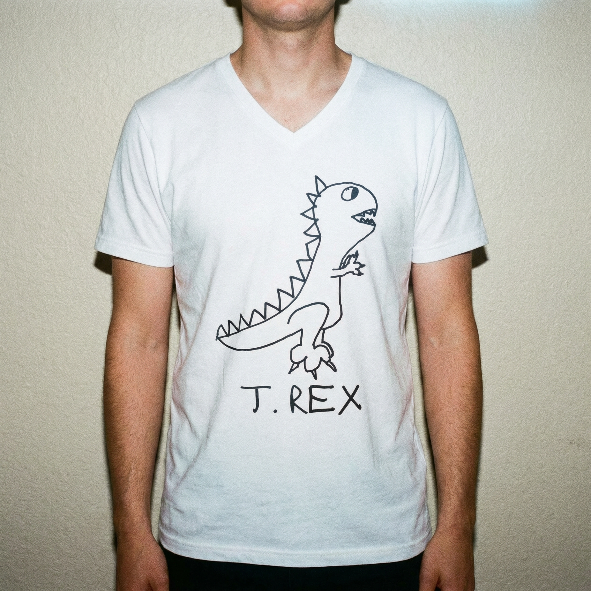 Model in T-Rex v-neck tee, bold stance, clean studio background