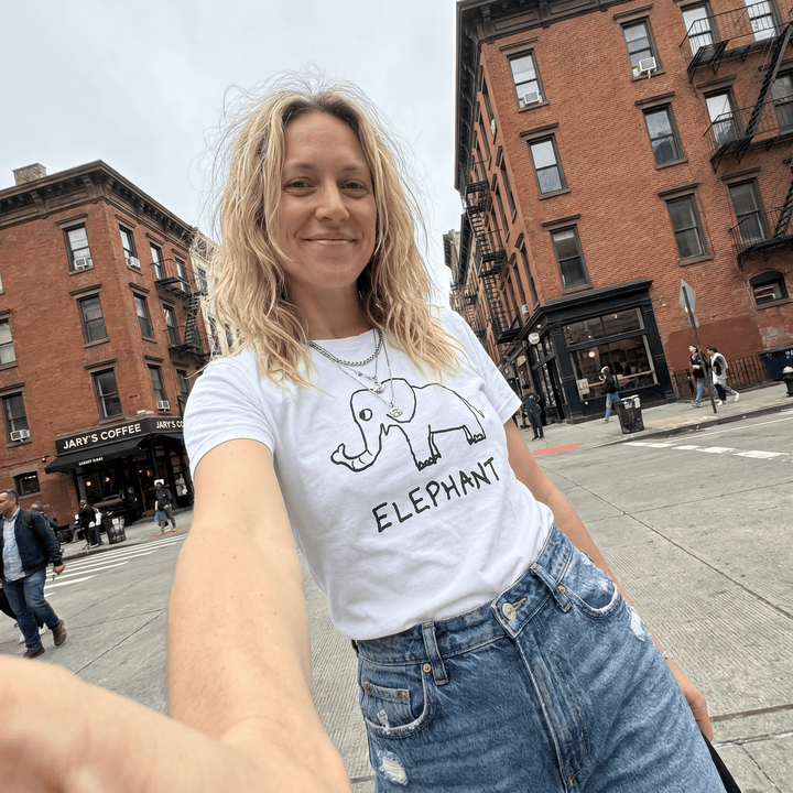 Woman taking a selfie on a city street wearing a lo-fi Elephant Women&