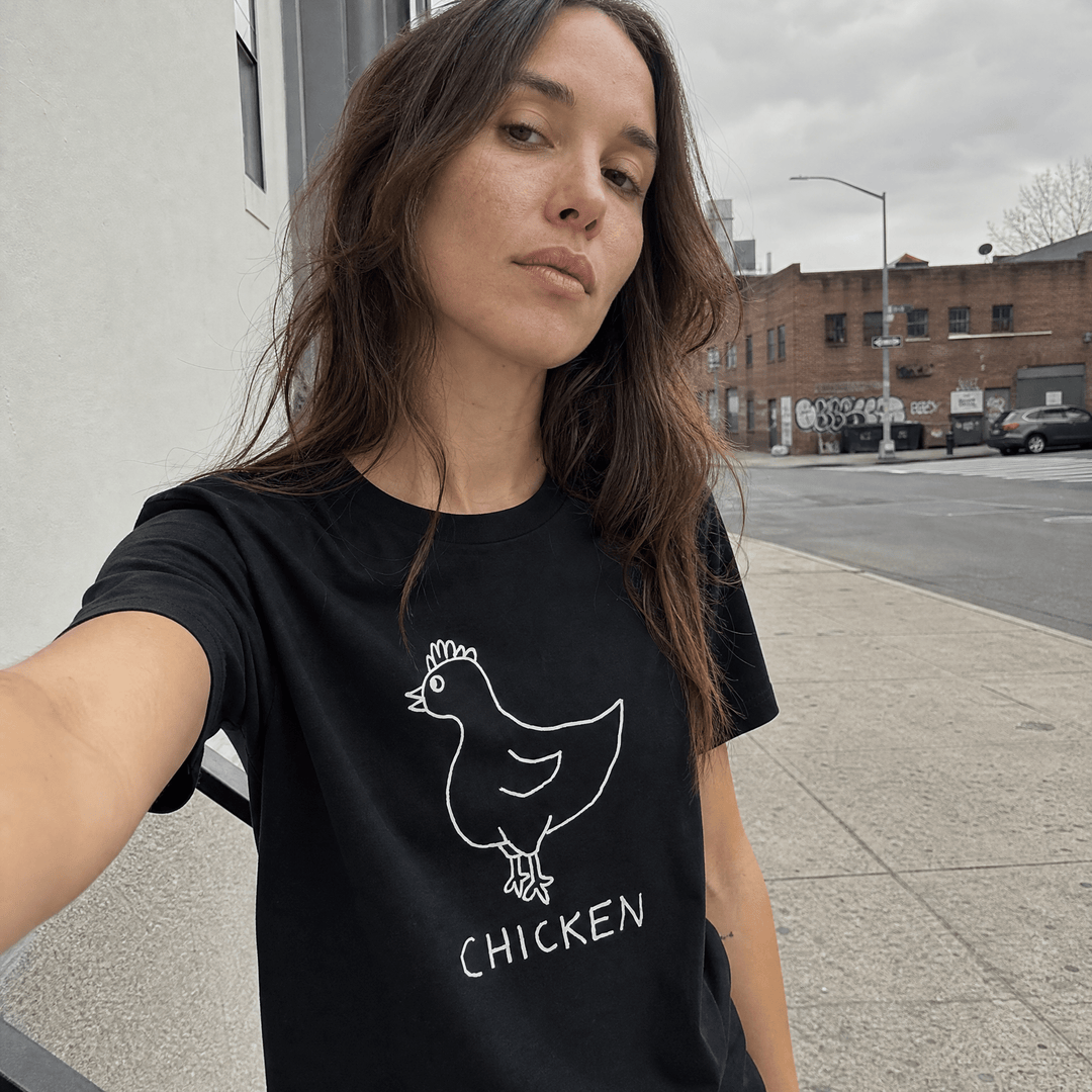 Woman taking a street selfie in a lo-fi Chicken Women&