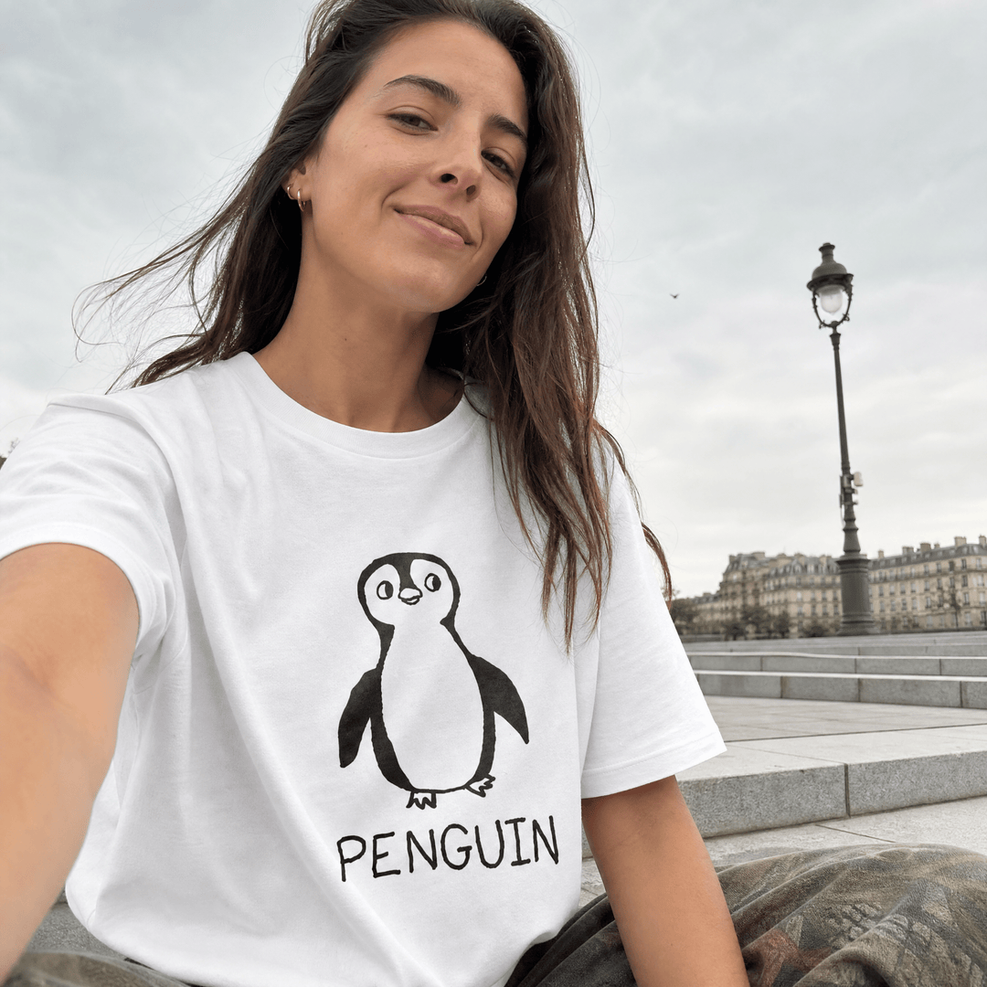 Woman taking a selfie by a Paris streetlamp wearing a lo-fi Penguin Women&