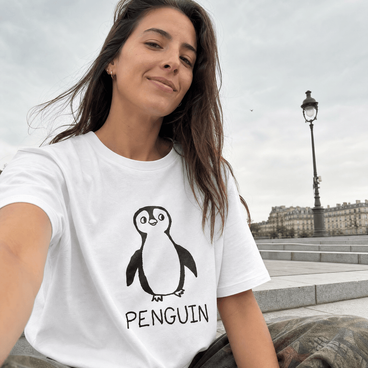Woman taking a selfie by a Paris streetlamp wearing a lo-fi Penguin Women&