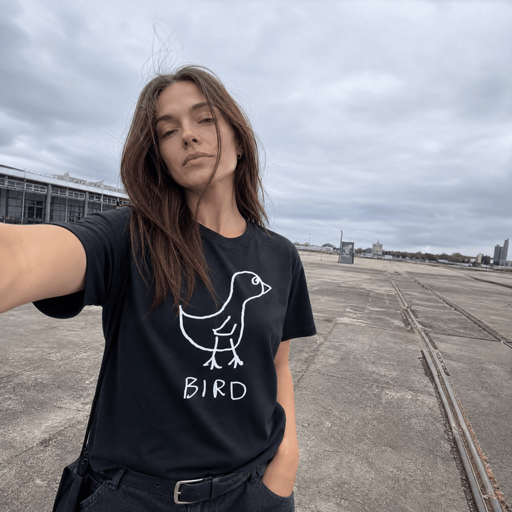 Woman taking a street selfie in a lo-fi Bird Women&