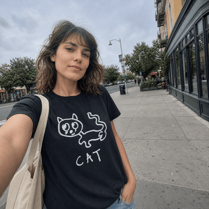 Woman taking a street selfie in a lo-fi Cat Women&