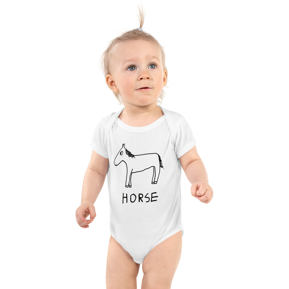 Cute baby wearing white one piece bodysuit with a horse drawing on it.