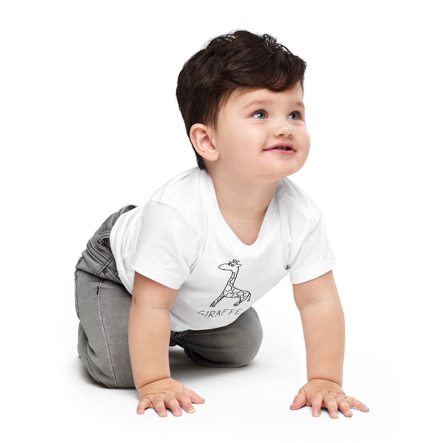 Toddler  wearing a white t-shirt with a simple hand drawn giraffe illustration and text, crawling on a white background