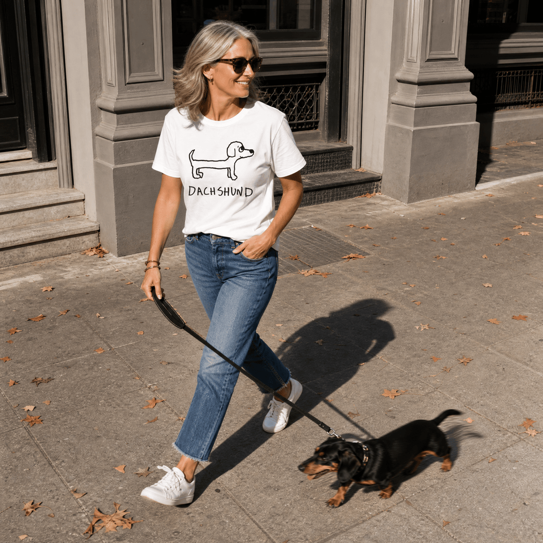 Woman walking a dog on a city street in a lo-fi Dachshund Women&