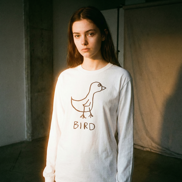 Model in a bird graphic long sleeve in a light, airy 90s-inflected editorial shoot