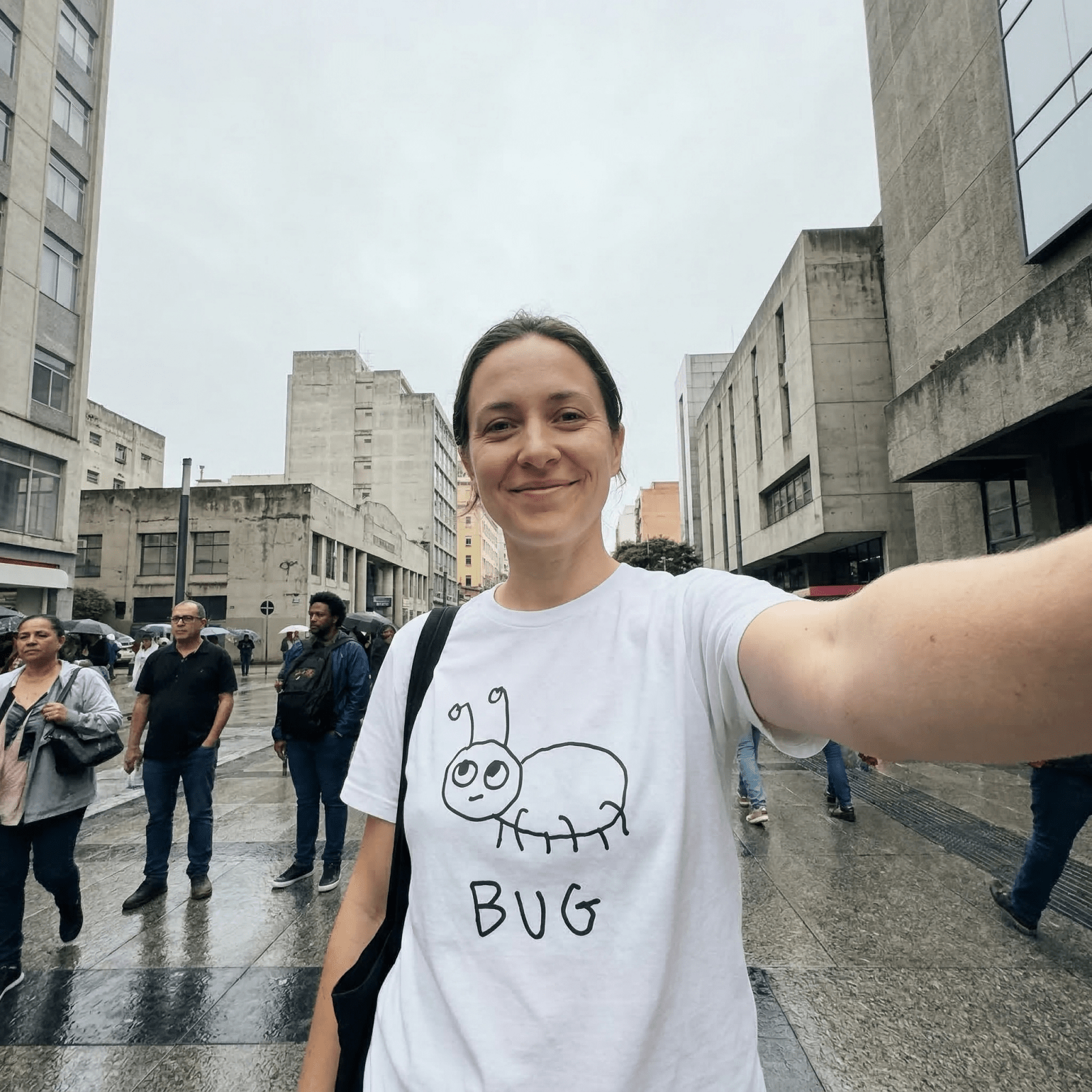 Woman taking a selfie on a city street wearing a lo-fi Bug Classic Tee