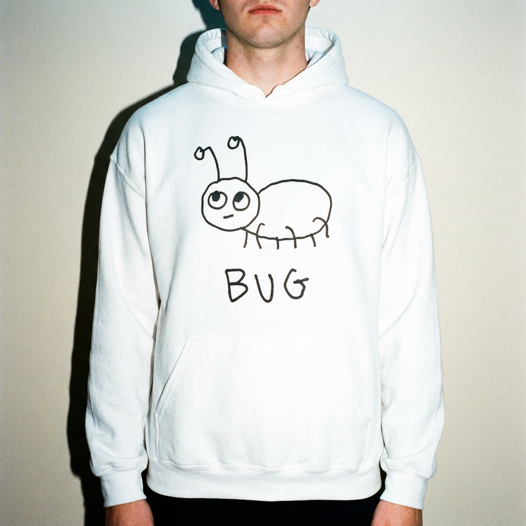 Man wearing a white hoodie with a quirky minimalist lofi BUG drawing and text. 